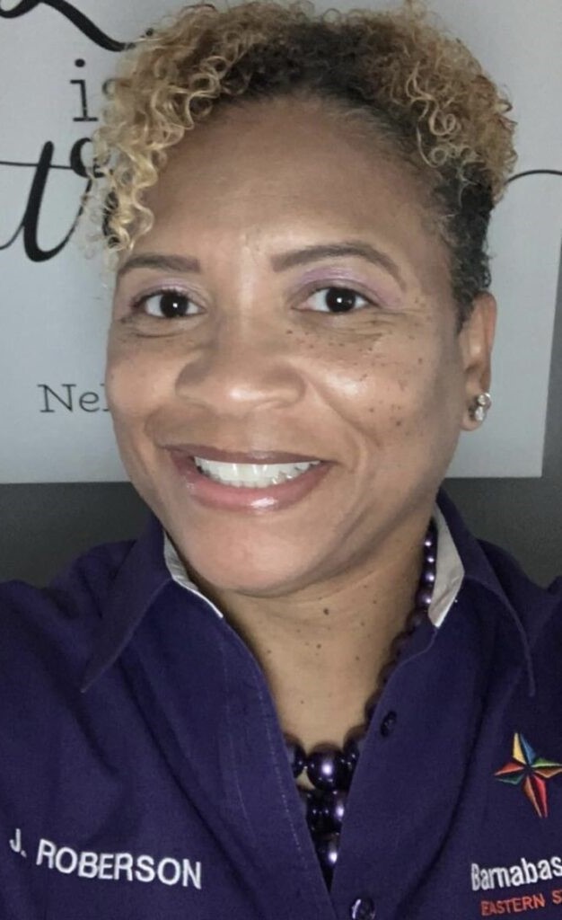 A woman with blonde hair and purple eye shadow.